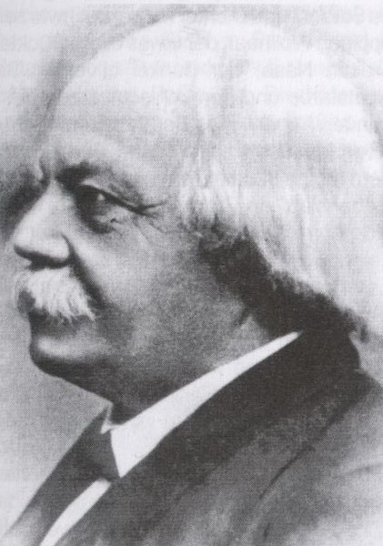 Photographie des alten Ludwig Schandeins Kopf im Profil. Halbglatze und Schnauzer, er trägt einen Anzug.